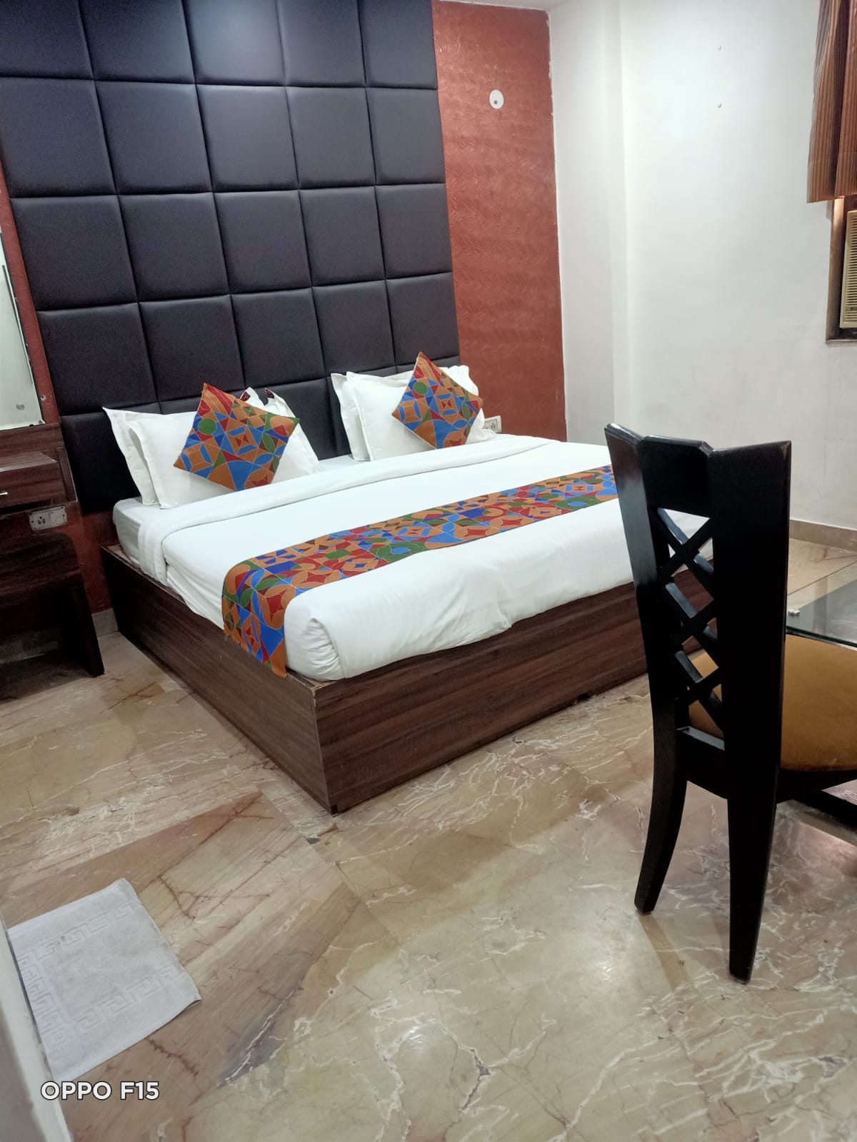 Deluxe Room — double bed with black padded headboard
