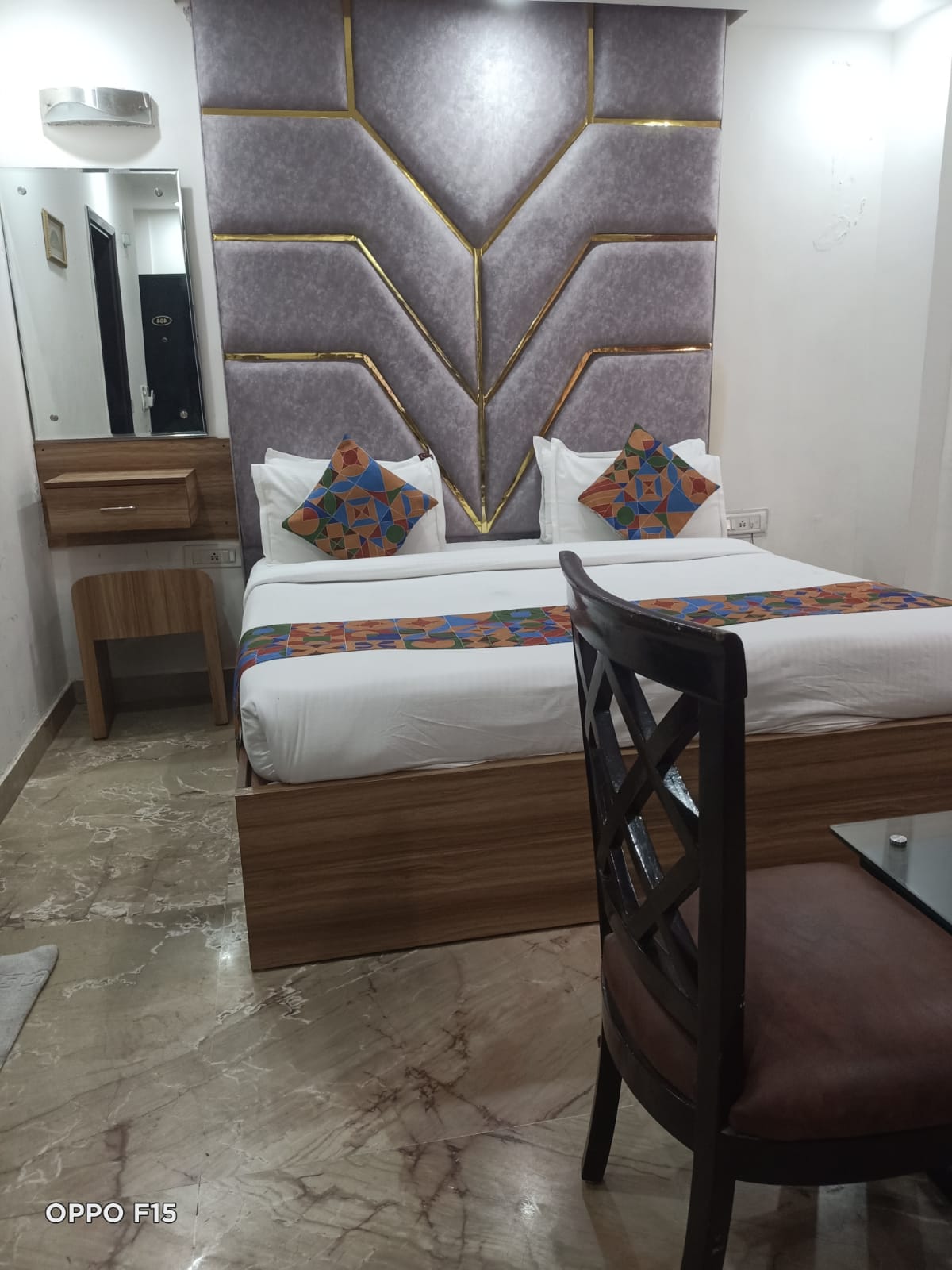 Deluxe Room — double bed with grey padded wall panel